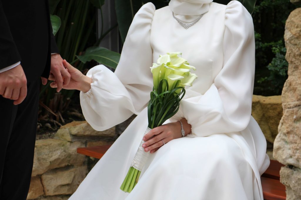 White calla lilies being held by a bride