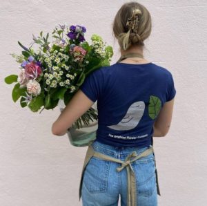 Brighton flower company employee holding a bunch of flowers