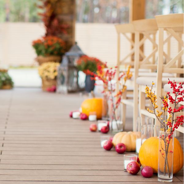 Autumnal aisle decorations with autumn flowers and pumpkins and berries