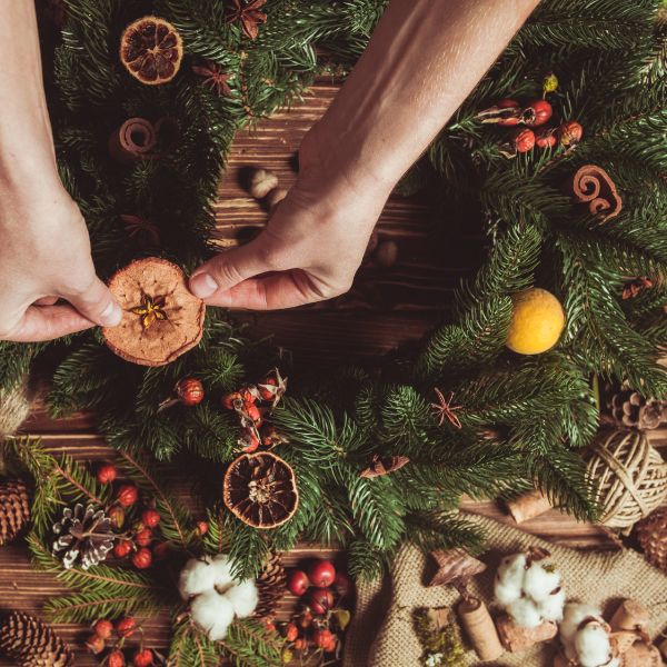 adding dried fruit to a christmas wreath