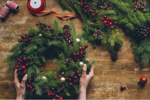 Person creating a christmas wreath