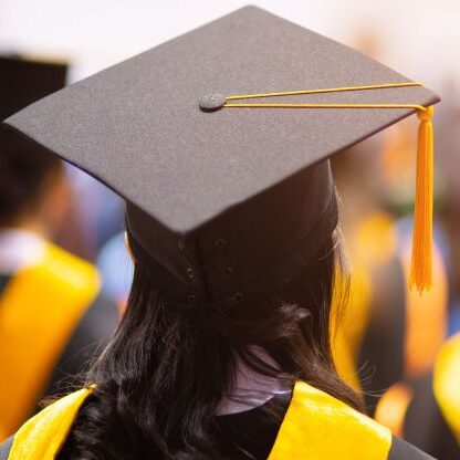 person wearing a graduation cap and gown