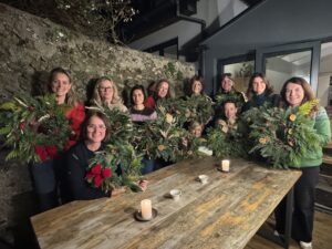 group of women doing a flower arranging class