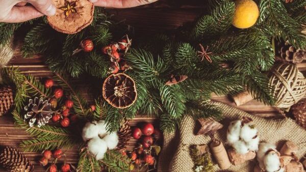 adding dried fruit to a christmas wreath